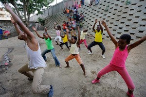 Dance instructor shows school children dance moves